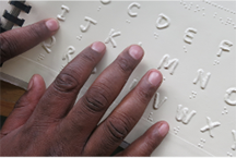 hands reading braille