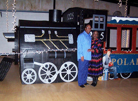Charlie Saunders and his wife in front of a train
