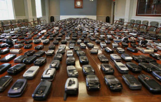 a lot of cell phones on a desk